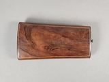 a small wooden object on a white surface