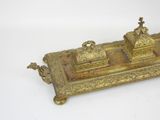 a gold colored inkwell with a cross on it