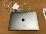 a laptop computer sitting on a table with a charger