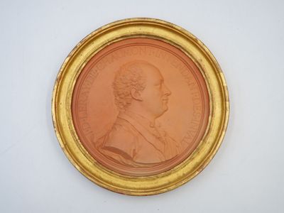 an old gold coin with a portrait of a man in profile