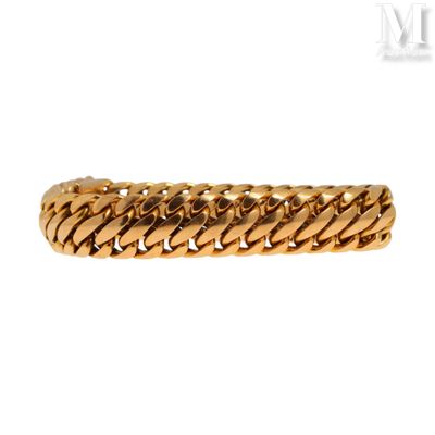 a close up of a gold bracelet on a white background