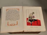 an open book with a picture of a man sitting at a table
