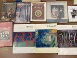 several books are sitting on a table next to a cup of coffee