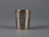 an antique silver cup with a lion emblem on the side