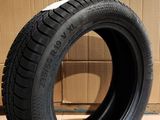 tire on the floor in front of a cardboard box with a cardboard box in the background