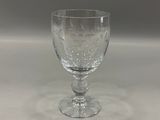 a wine glass that is sitting on a table