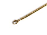 a close up of a gold chain on a white background