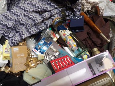 a suitcase full of stuff that is sitting on the floor