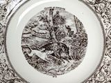 a black and white plate with a picture of a bird on it