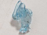 a small blue glass figurine sitting on a white surface