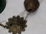a metal object with a chain attached to it on a table