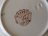 a white plate with a brown design on it