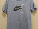a blue shirt with a black nike logo on it