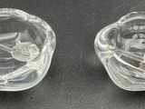 pair of clear glass figurines of a man and a woman