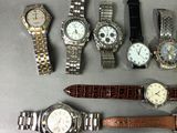 a lot of watches that are sitting on a table