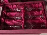 six wine glasses in a pink box on a table