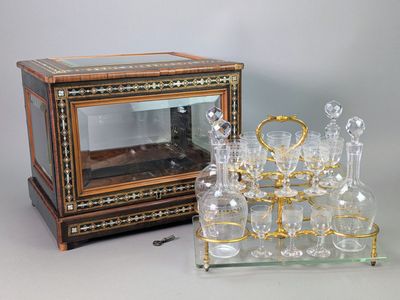 a glass display case with a lot of wine glasses on it