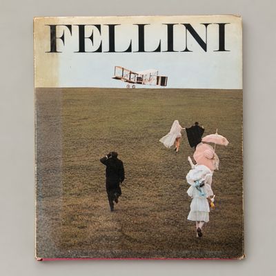 a book with a picture of a couple of people walking in a field