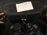 a black case with a pair of binoculars next to it