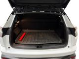the back of a white car with the trunk open showing the cargo compartment