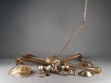a lot of brass objects that are on a table