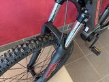 a close up of a bicycle parked against a red wall