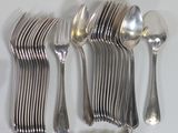 a lot of silver spoons and spoons on the table