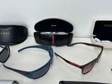 several pairs of sunglasses and a pair of glasses are sitting on a table