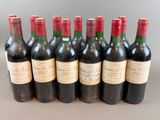 six bottles of wine are lined up in a row on a table