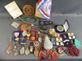 a lot of medals and other items on a table