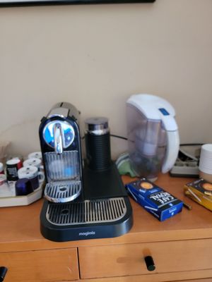 a coffee maker on a dresser in a room