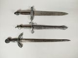 three different types of swords are displayed on a white surface