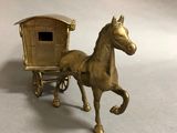 a gold horse drawn carriage with a horse drawn carriage