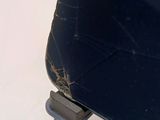 a broken cell phone sitting on top of a stand