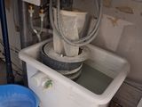 a blue bucket sitting next to a sink in a room