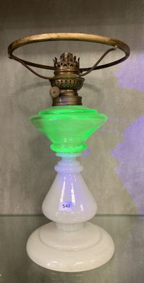 a green glass lamp that is sitting on a glass table