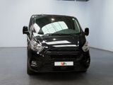 the black van is parked in a large room with white walls
