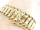 bracelet on a woman ' s arm with a gold chain bracelet