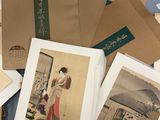 a lot of old asian paintings on the table
