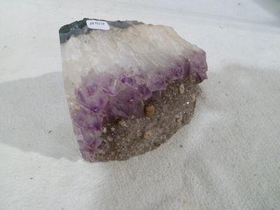 a piece of rock with a purple substance on top of it
