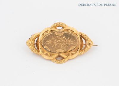 a close up of a coin in a gold brooch