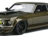 the toy car is green and has black rims on it