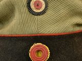 an image of a military hat with a button on it