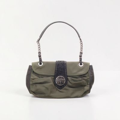 a green purse with a black handle on a white background