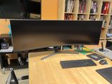 a computer desk with a monitor, keyboard, mouse and mouse