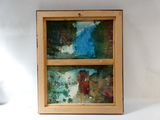 a picture of a painting hanging on a wall next to a vase