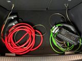 two wires in the trunk of a car with headphones in it