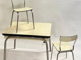 two chairs and a table with a chair on top of it