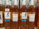bottles of wine are lined up on a shelf in a store