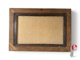 an old picture frame with a picture hanging on the wall